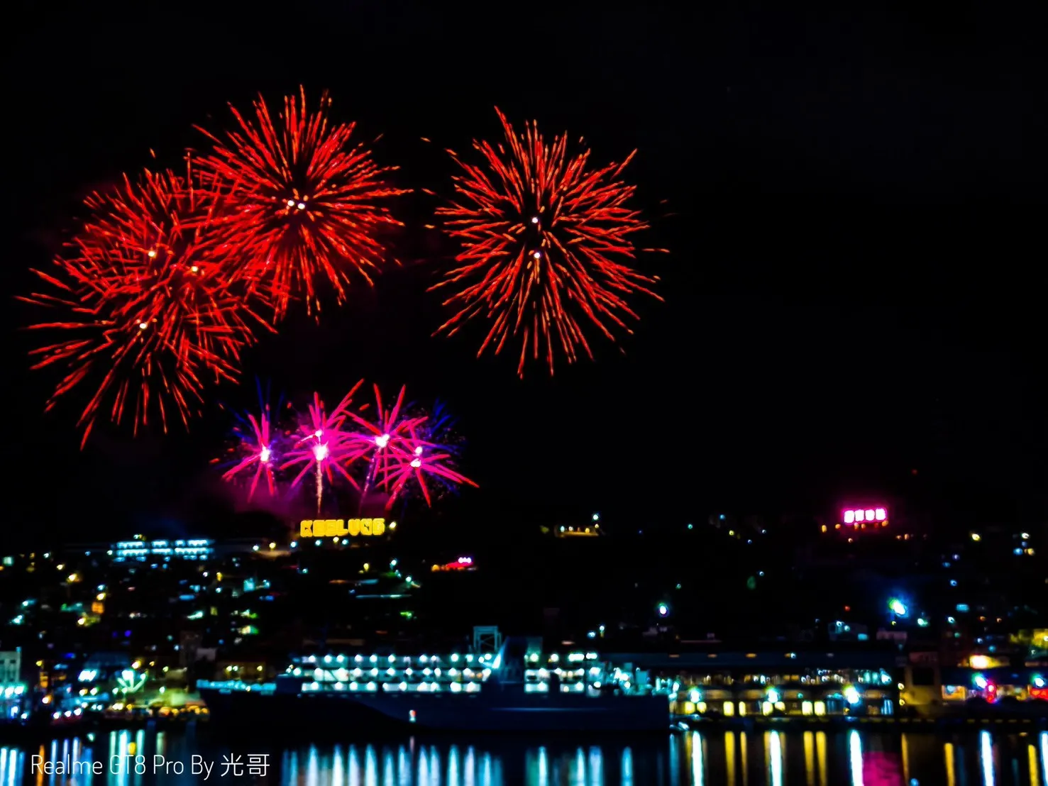 基隆開港祭紅色高空煙火與粉紅星點煙火同時照亮地標